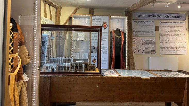 view of a room set up for an exhibition with show cases and displays